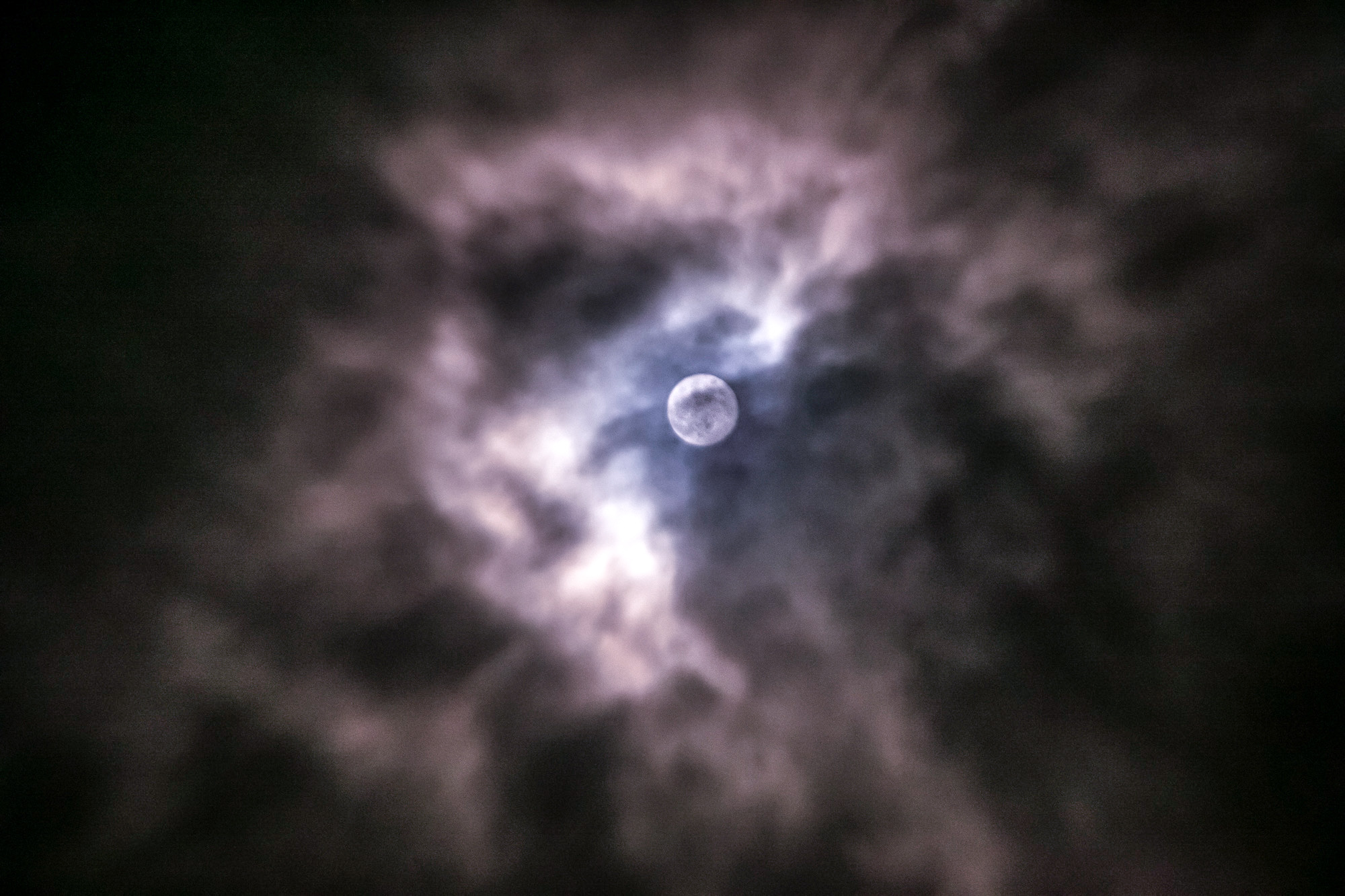 Full Moon breaking through clouds photographed by Deep Sky Hawaiʻi